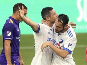 Montreal Impact's Blerim Dzemaili, middle, celebrates with Matteo Mancosu after Dzemaili scored a goal against Orlando City during an MLS soccer match Saturday, June 17, 2017, in Orlando, Fla.