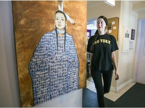 February 2016: A frontline worker walks by painting by Jonathan LaBillois depicting missing and murdered indigenous women at the Native Women's Shelter. The centre survives on a combination of "bare bones" provincial funding, federal grants and private donations.
