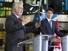 Quebec Premier Philippe Couillard, left, speaks as Prime Minister Justin Trudeau listens in Montreal July 5, 2016.