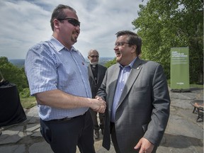 MONTREAL, QUE.: JUNE 10, 2017 -- Mayor Denis Coderre right speaks with Grand Chief, Mohawk Government of Akwesasne Abram Benedict left, after the ceremony for the inauguration of Parc Tiohtia:ke Otsira'kehne, previously known as the Outremont summit that looks out over the Universite de Montreal, in Montreal, on Saturday, June 10, 2017. (Peter McCabe / MONTREAL GAZETTE) ORG XMIT: 58799