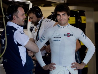 Williams Racing's Lance Stroll speaks with a team member as he waits for the start of the morning practice round during the Canadian Formula 1 Grand Prix at Circuit Gilles Villeneuve in Montreal on Saturday June 10, 2017.