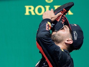 Daniel Ricciardo of Red Bull Racing drinks champagne from his shoe, which he threw to the crowd afterward, after taking 3rd place in the Canadian Formula 1 Grand Prix at Circuit Gilles Villeneuve in Montreal on Sunday, June 11, 2017.