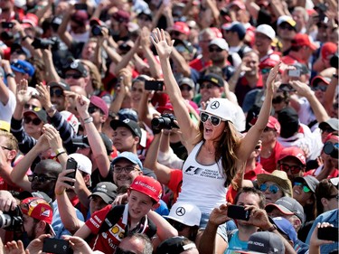 Fans cheer for Lewis Hamilton of Mercedes Petronas as he is introduced as the winner of the Canadian Formula 1 Grand Prix at Circuit Gilles Villeneuve in Montreal on Sunday, June 11, 2017.