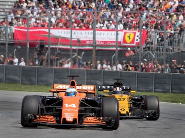 Fernando Alonso of McLaren Honda and Nico Huldenberg of Renault Sport battle through a corner during the Canadian Formula 1 Grand Prix at Circuit Gilles Villeneuve in Montreal on Sunday, June 11, 2017.