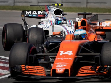 Montrealer Lance Stroll of Williams Racing tries to get inside Fernando Alonso of McLaren Honda during the Canadian Formula 1 Grand Prix at Circuit Gilles Villeneuve in Montreal on Sunday, June 11, 2017. Stroll went on to pass Alonso on the lap and finished the race in 9th place.