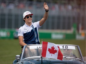 Lance Stroll waves to the fans during the driver's parade during the Canadian Formula 1 Grand Prix at Circuit Gilles Villeneuve in Montreal on Sunday June 11, 2017.