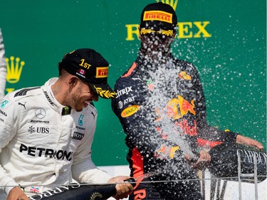 Lewis Hamilton of Mercedes Petronas, left, and Daniel Ricciardo of Red Bull Racing spray each other with champagne after Hamilton won the Canadian Formula 1 Grand Prix at Circuit Gilles Villeneuve in Montreal on Sunday, June 11, 2017. Ricciardo took 3rd place in the race.