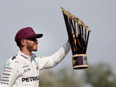 Lewis Hamilton of Mercedes Petronas waves the trophy to a crowd of fans after winning the Canadian Formula 1 Grand Prix at Circuit Gilles Villeneuve in Montreal on Sunday, June 11, 2017.