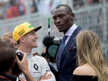 Nico Hulkenberg of Renault Sport speaks with  NBA player Bismack Biyombo and Montreal tennis star Eugenie Bouchard on the starting grid during the Canadian Formula 1 Grand Prix at Circuit Gilles Villeneuve in Montreal on Sunday, June 11, 2017.