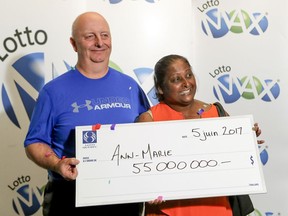 Ann-Marie Francis and husband Ian Warcup with their $55,000,000 cheque for having won the June 2 Lotto Max draw during a ceremony in Montreal Monday June 5, 2017.