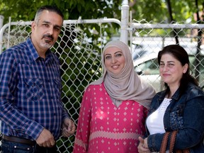 Lana Kanaan, centre, a support worker for Syrian refugees, with Nashwan Kassis and Howida Tannous at Relais communautaire de Laval on Wednesday.