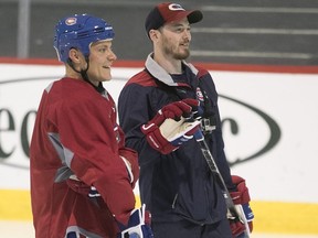 Sporting a Canadiens uniform, F1 driver Valtteri Bottas, left, and Habs' Paul Byron take a break during promotional event at the Bell Sport Complex in Brossard on Wednesday June 7, 2017.