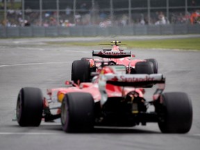 Ferrari's Sebastian Vettel and Kimi Raikkonen leave the pits together during practice session at the Canadian Formula 1 Grand Prix at Circuit Gilles Villeneuve in Montreal on Friday June 9, 2017.