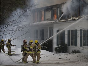 Firefighters battle a house fire in St-Lazare in March 2016.