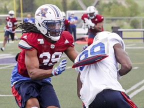 Defensive back Donald Unamba Jr., left, stops reciever T.J. Graham during Montreal Alouettes training camp at Bishop's University in Lennoxville, southeast of Montreal Monday May 29, 2017.