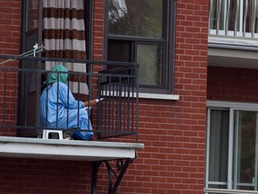 A woman reads on her balcony in the Park Ex district of Montreal.