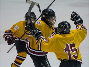 Arnaud Durandeau (middle) of the Lac St. Louis Lions celebrates his 1st period goal with team-mates against Laurentides-Lanaudiere Phenix during Hockey Quebec's U-13 hockey tournament held at Bell Sports Complex in Brossard on May 26, 2012.