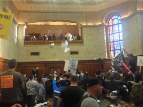Montreal firefighters and municipal employees protesting against pension reforms stormed city hall on Aug. 18, 2014, tossing papers throughout the building and in council chambers minutes before city council was scheduled to begin its evening session.