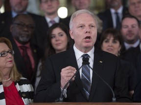 Parti Québécois Leader Jean-François Lisée, centre, accompanied by members of his caucus, speaks at a news conference marking the end of the spring session, Friday, June 16, 2017 at the legislature in Quebec City.