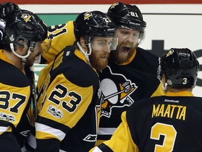 Pittsburgh Penguins' Phil Kessel, right rear, celebrates his goal against the Nashville Predators with Sidney Crosby (87), Scott Wilson (23) and Olli Maatta, right, during the second period in Game 5 of the NHL hockey Stanley Cup Final, Thursday, June 8, 2017, in Pittsburgh.