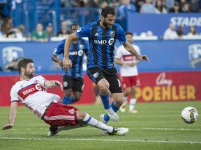 Toronto FC defender Drew Moor, left, knocks the ball away from Montreal Impact midfielder Ignacio Piatti during first half of the first leg of the Canadian Championship soccer final action, in Montreal on Wednesday, June 21, 2017.