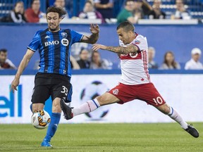 Montreal Impact midfielder Marco Donadel, left, and Toronto FC forward Sebastian Giovinco battle for the ball during second half of the first leg of the Canadian Championship soccer final action, in Montreal on Wednesday, June 21, 2017.