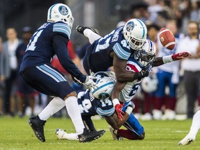 Alouettes' TJ Graham has pass broken up by Argonauts' Terrance Plummer (47), Qudarius Ford (14), and Justin Tuggle (51), during the first half of CFL pre-season action in Toronto, Thursday June 8, 2017.