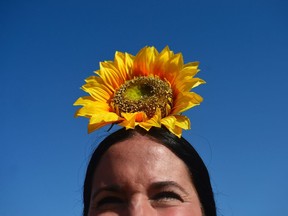 Photo of the day: A pilgrim sporting a sunflower she crosses the Quema river during the annual El Rocio pilgrimage in Villamanrique, June 1, 2017. El Rocio pilgrimage is the largest in Spain with hundreds of thousands of devotees wearing traditional outfits converging in a burst of colour as they make their way on horseback and decorated carriages across the Andalusian countryside.