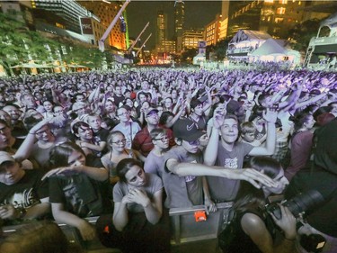 Walk Off the Earth fans are bathed in blue light during outdoor blowout concert at the Montreal International Jazz Festival in Montreal Tuesday July 4, 2017.