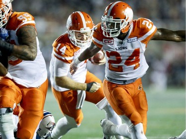 British Columbia Lions quarterback Travis Lulay follows the block by running back Jermiah Johnson, right, for the winning touchdown during fourth quarter of Canadian Football League game against the Alouettes in Montreal Thursday July 6, 2017.