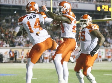 British Columbia Lions quarterback Travis Lulay celebrates his game-winning touchdown with running back Jermiah Johnson and Jas Dhillon during fourth quarter of Canadian Football League game against the Alouettes in Montreal Thursday July 6, 2017.