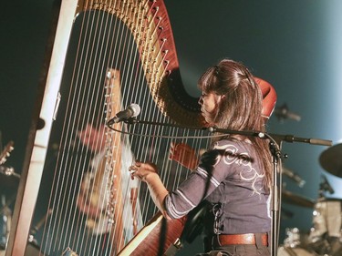 Sarah Pagé plays harp with the Barr Brothers during their concert at the Montreal International Jazz Festival in Montreal Friday July 7, 2017.