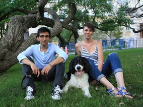 Oreo the English Springer Spaniel and owners Amir Kadivar and Emily Gilmour sit under a fine tree on a fine summer day at McGill University's downtown campus.