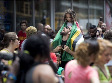 Krzysztof Spaleniec checks on his daughter, Marley Leblanc Spaleniec, as they enjoy the annual Carifiesta parade in Montreal on Saturday July 8, 2017.