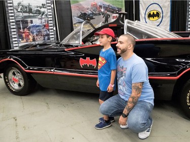 Anthony Turano and his six-year-old son, David Turano, pose for a picture with a replica Batman car at Comiccon in Montreal on Sunday July 9, 2017.