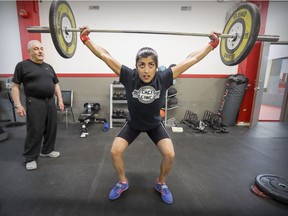 Coach John Margolis supervises Fereshteh Dinaz Bulsara as she trains at Concordia-International Weightlifting Club's temporary location in Verdun. Many young people, he said, aren’t interested in team sports which can also be costly, but they take a liking to individual sports like weightlifting and that’s “better than diddling with their phones or video games all day.”