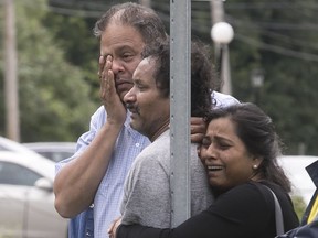 Friends and family wait for news after a man disappeared into the Rivière-des-Rapides in July 2017.