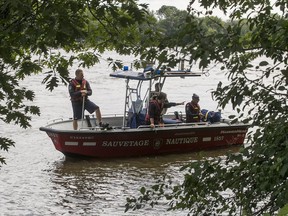 Firefighters search Riviere-des-Prairies, near Rapides du Cheval Blanc Park in Pierrefonds July 10, 2017, for a man who vanished into the river Sunday.