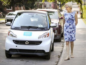 Jo-Anne Wemmers walks by a Car2Go car sharing vehicle parked in her Notre-Dame-de-Grace neighbourhood. She is among a growing number of Montrealers who think car sharing vehicles are taking up too many parking spaces.
