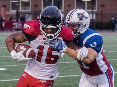 Montreal Alouettes linebacker Chip Cox (11) brings down Calgary Stampeders slotback Marquay McDaniel (16) during first half CFL action at Molson Stadium in Montreal on Friday, July 14, 2017.