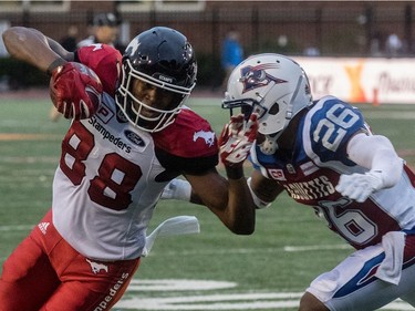 Montreal Alouettes defensive back Tyree Hollins (26) runs down Calgary Stampeders slotback Kamar Jorden (88) during 1st half CFL action at Molson Stadium in Montreal, on Friday, July 14, 2017.