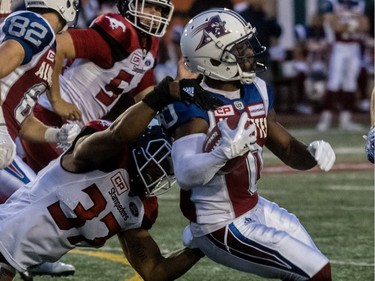 Montreal Alouettes running back Stefan Logan (0) broke free of the tackle by Calgary Stampeders linebacker Maleki Harris (37) during 1st half CFL action at Molson Stadium in Montreal, on Friday, July 14, 2017.
