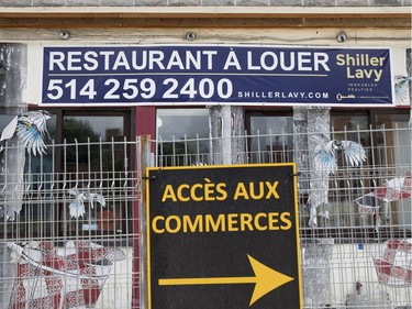 A shuttered restaurant is for rent behind a construction safety fence at the corner of Rose-de-Lima and Notre-Dame Street in Montreal, on Monday, July 17, 2017.