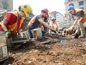Archeologists work at the site of Canada's first parliament at Place-d'Youville in Old Montreal, hoping to uncover personal objects left behind by parliamentarians when they rushed out of the building after it was torched by an angry mob in 1849.