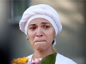 A woman cries during a ghost bike ceremony for cyclist Meryem Anoun in Montreal July 21, 2017. The woman said she was a witness to the accident.