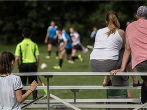 Fans peacefully watch the U-14 boys soccer game between Lakeshore and Pierrefonds in Beaconsfield on Sunday.