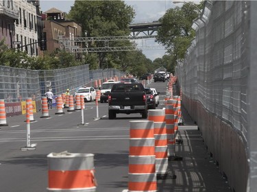 Cars on René Lévesque try to negotiate orange cones as they make their way east on Wednesday, July 26, 2017. The road will be part of the E Formula race over the weekend.