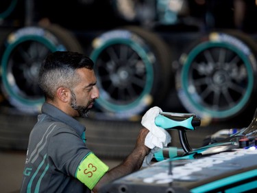 A Jaguar Racing mechanic puts the finishing touches on a car during the open house for the Formula E in Montreal on Friday, July 28, 2017.