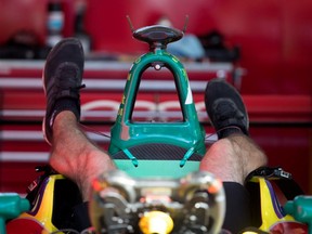 An Audi team mechanic dives head first into car preparation during the open house for the Formula E in Montreal July 28, 2017.