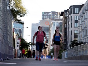 Some say the the Formula E race is a sign electric cars are gaining popularity. Here fans walk along the track during an open house Friday.